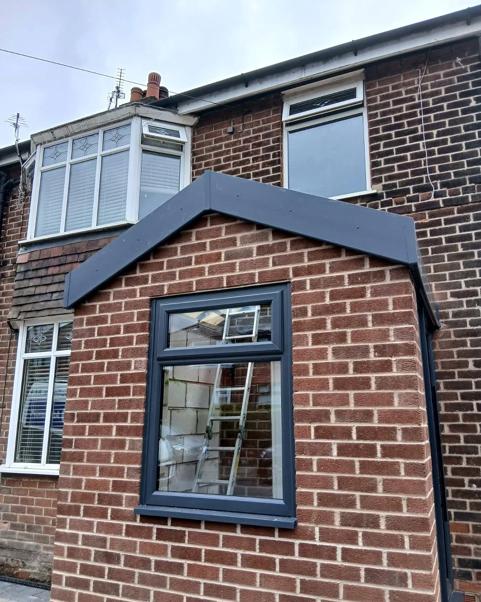 New brick porch with a lead-grey pitched roof and an anthracite window