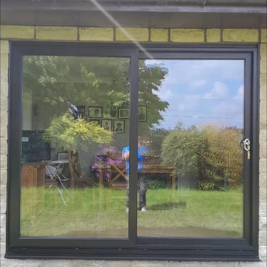 After: one wide sliding door opened into the same stone wall