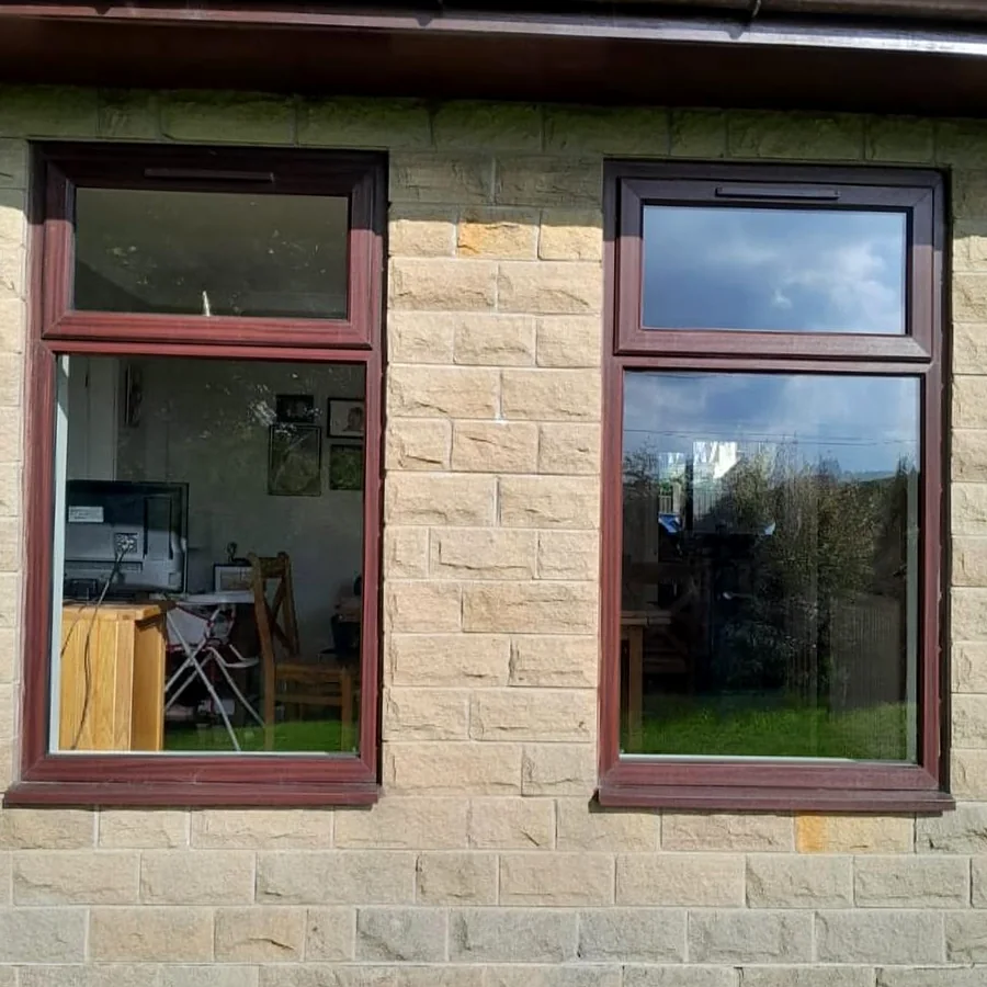 Before: two brown-framed windows in a stone wall