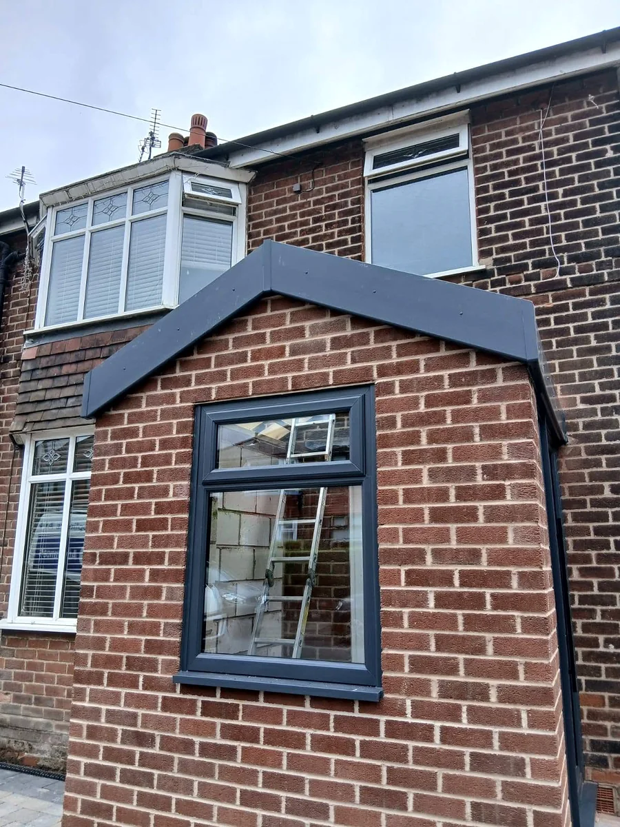 New brick porch with a lead-grey pitched roof and an anthracite window