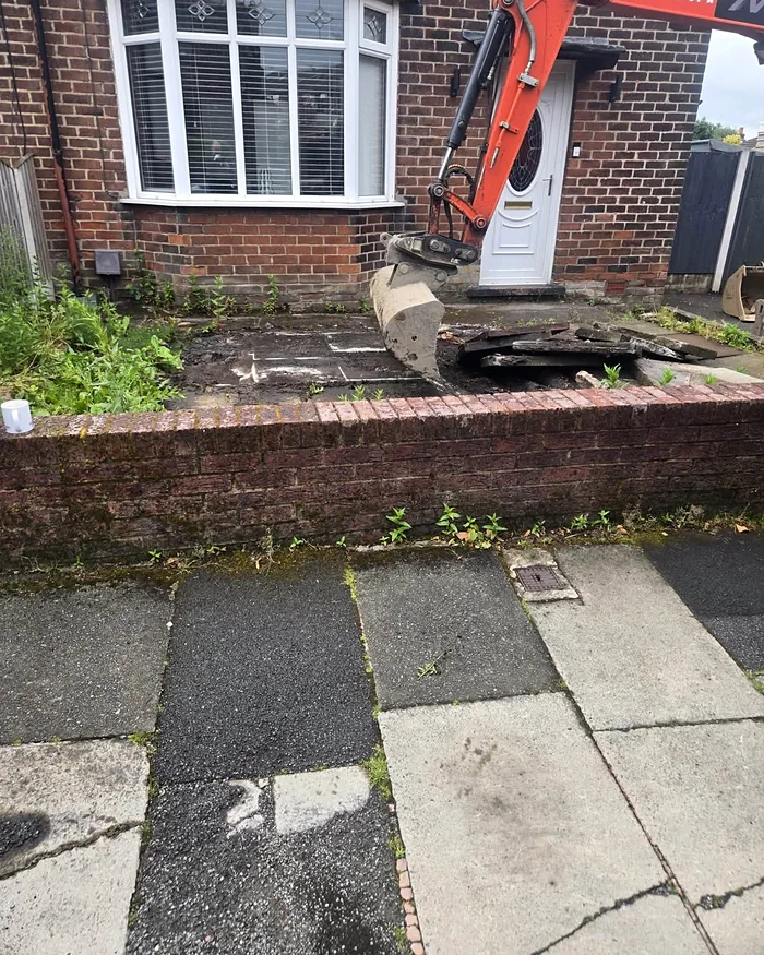 The front before: old flags and a mini digger on site