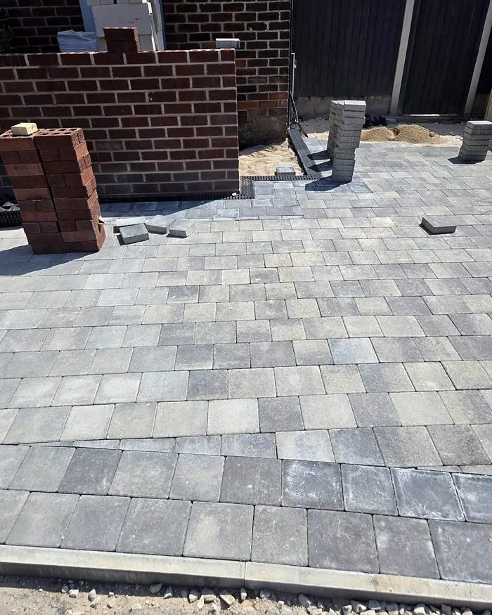 Porch walls going up and the new paving laid