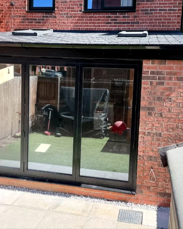 Brick extension with black-framed bifold doors